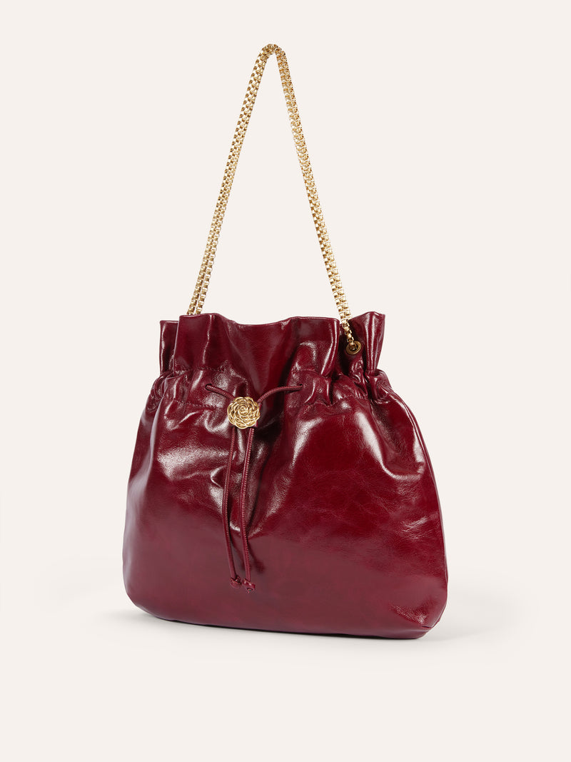 ARTISTE burgundy patent leather purse worn on a model by Rouje