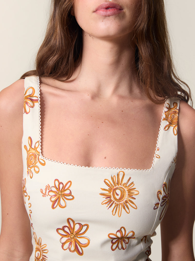 Close up of the square neckline of the sun print Elny dress.