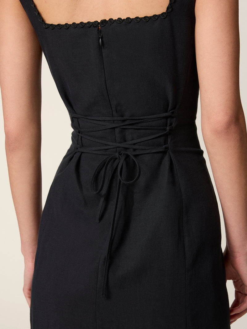 Back view of the black Elny dress tied at the waist.