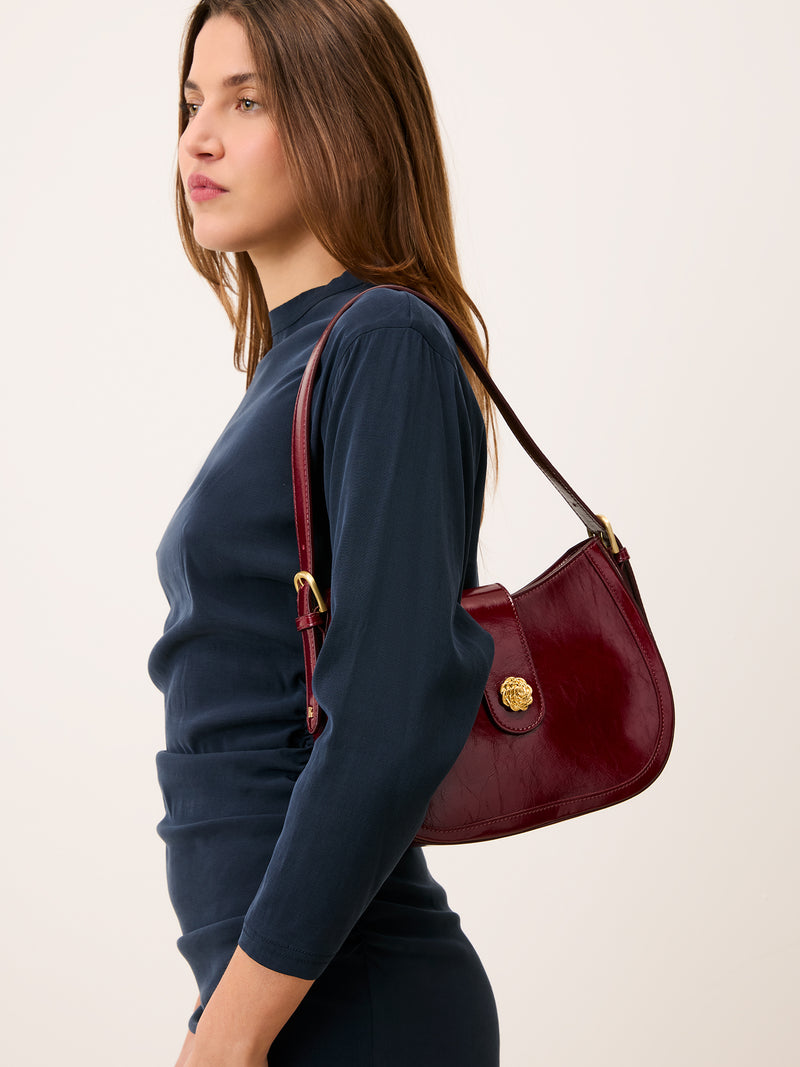 GALA burgundy vintage patent leather handbag worn on a model by Rouje