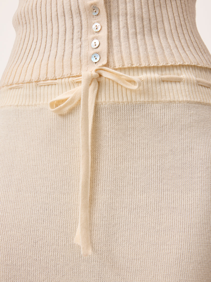Close up on the drawstring waist of Lester ecru maxi knit and crochet skirt