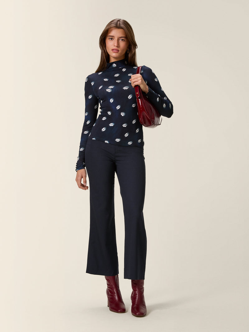 SWAN midnight wool flare trousers worn on a model by Rouje